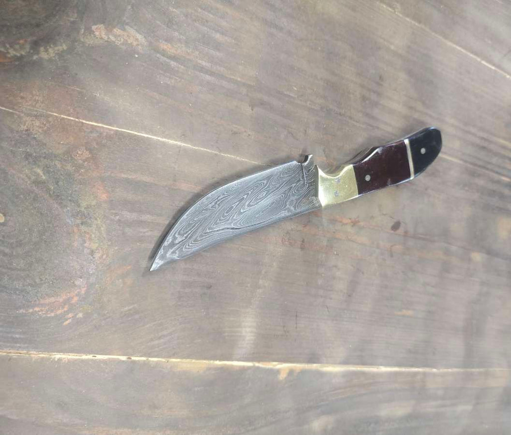 Alabama Damascus EDC knife with maroon and black Micarta handle and brass bolster