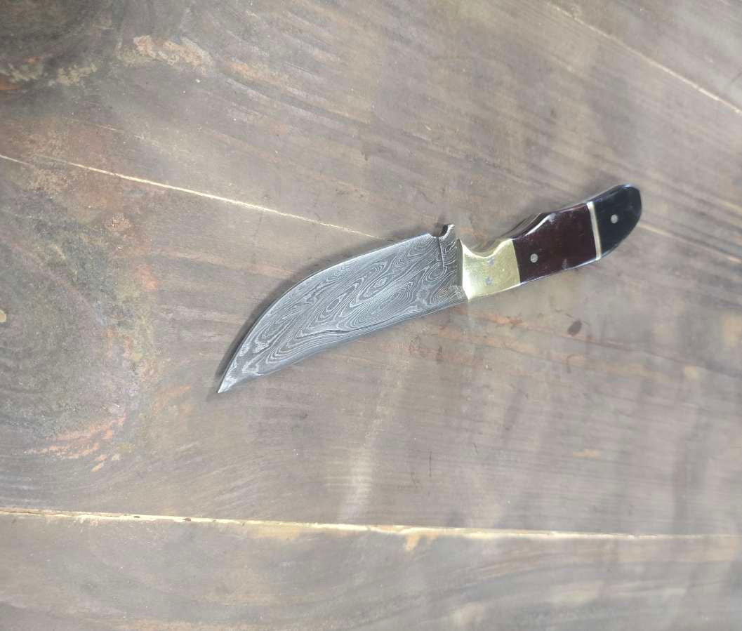 Alabama Damascus EDC knife with maroon and black Micarta handle and brass bolster