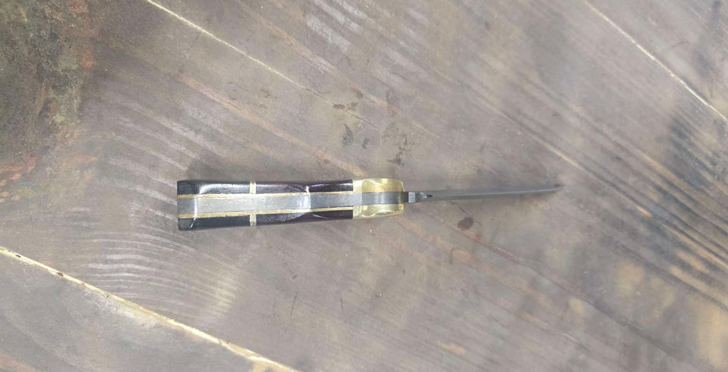 Spine view showing brass inlay and segmented Micarta handle